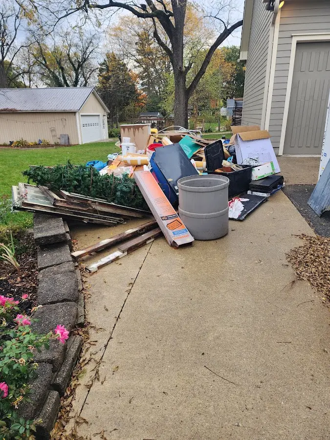 Dumpster being loaded with debris for 12 Yard Dumpster Rental in Lauderhill